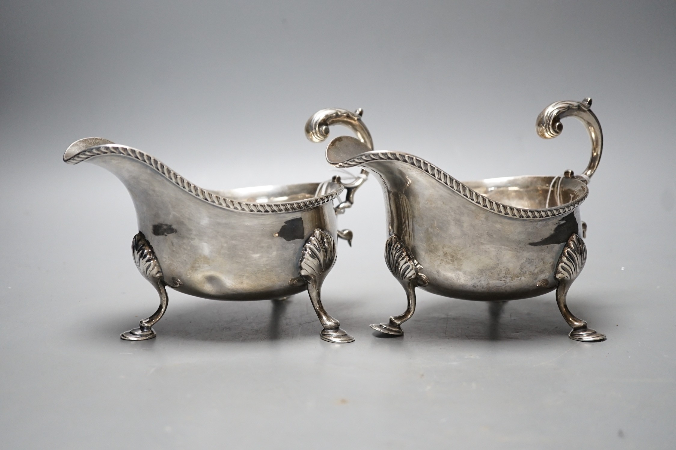 A pair of Edwardian silver sauceboats, with flying scroll handles, Nathan & Hayes, Chester, 1902, 17.7oz.